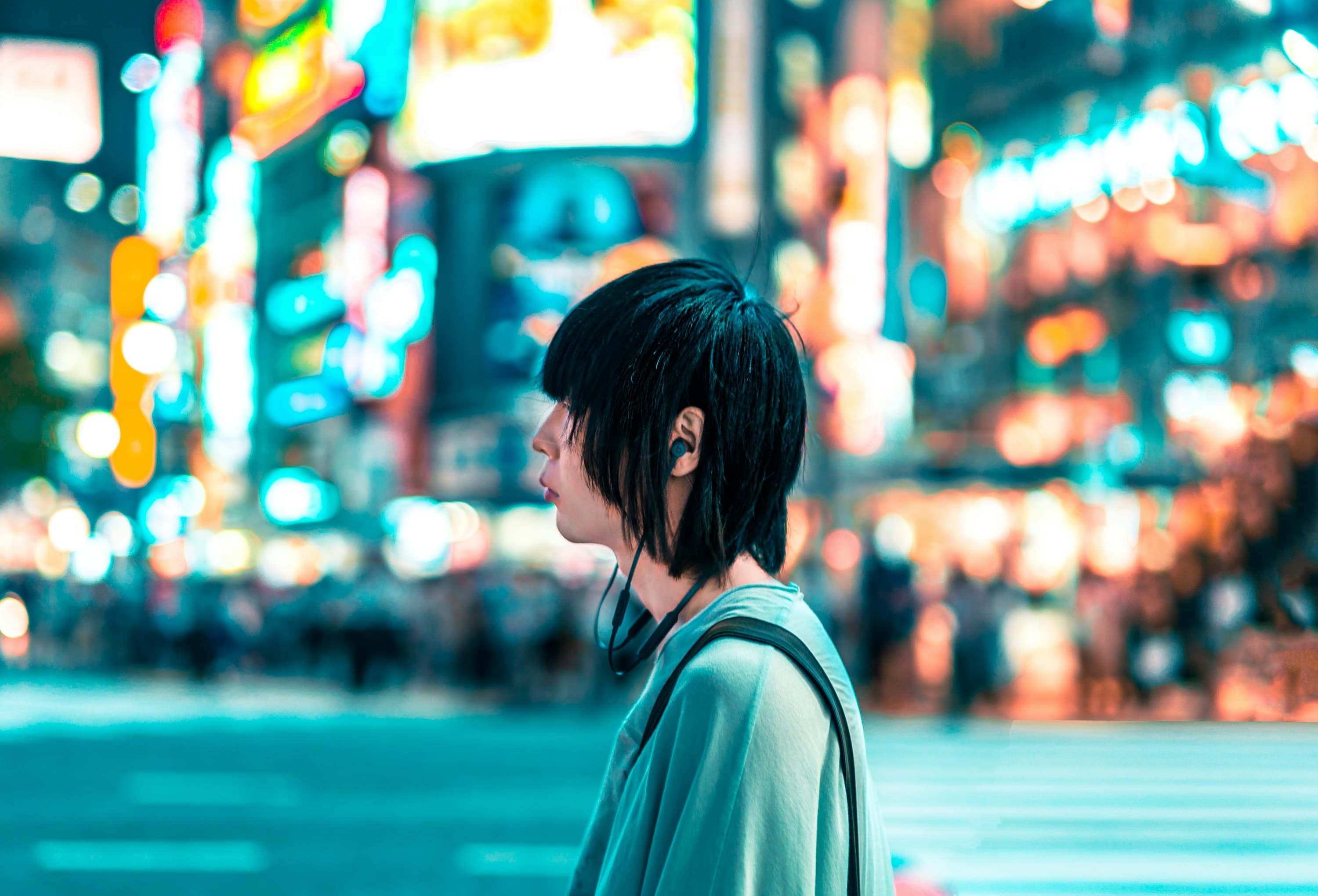 Traveler among the neon lights of Shibuya, Tokyo